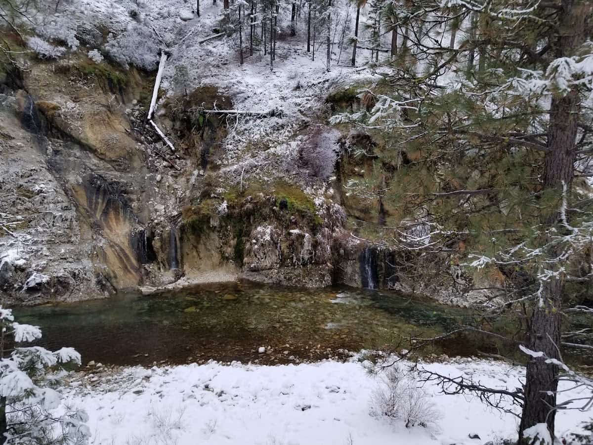 Outdoor hillside natural hot spring pool in a winter setting at browns creek hot spring idaho
