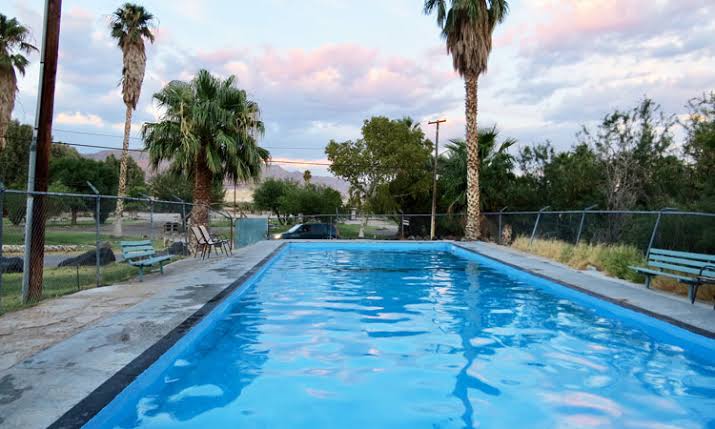 Outdoor palm tree lined hot spring pool at shoshone hot springs california