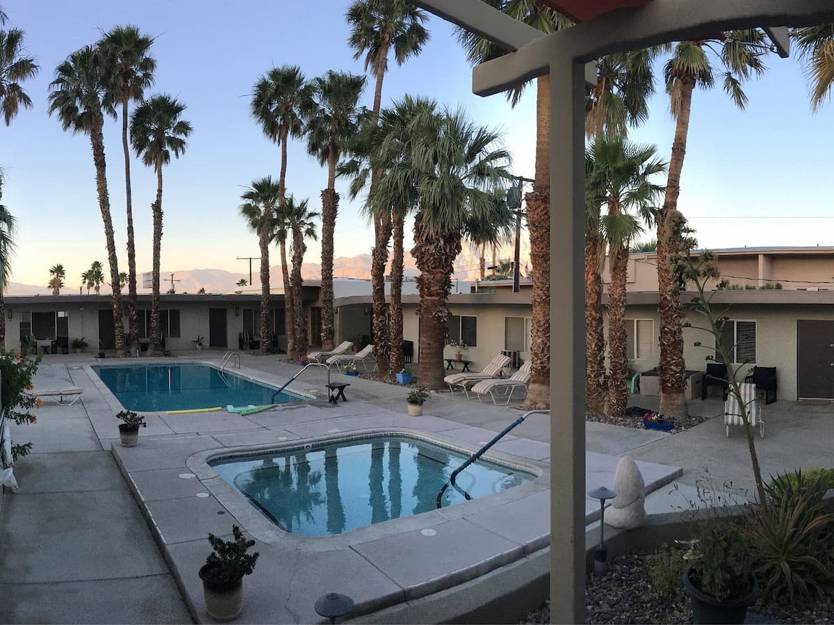 outdoor palm lined hot spring pool at lido palms resort and spa california