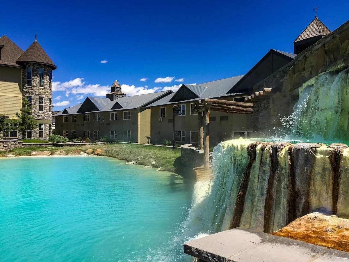 Travertine hot springs and a hot spring pool with resort in the background at pagosa springs mother spring colorado