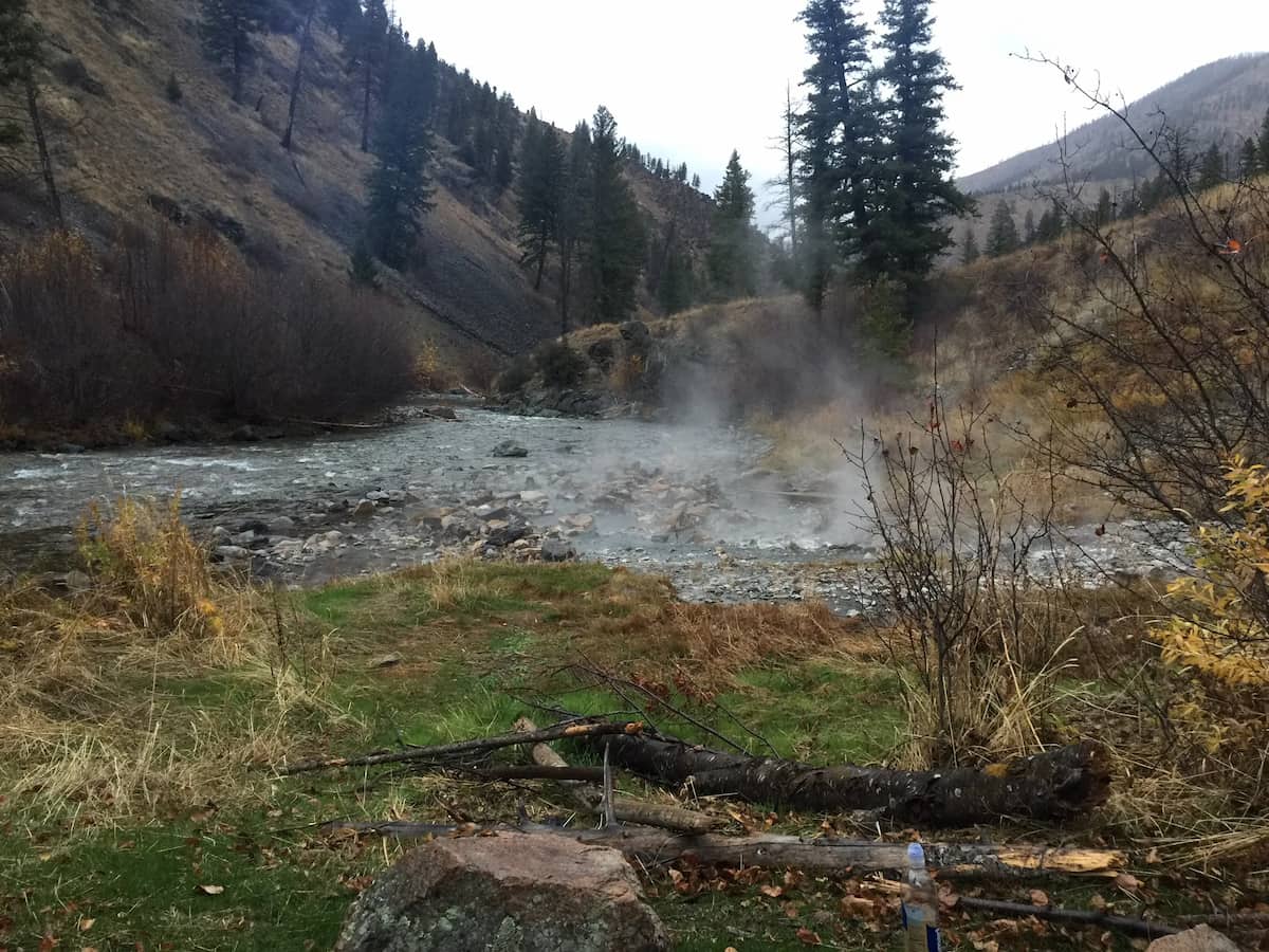 natural steaming hot spring pool alongside river at lower loon creek hot spring idaho