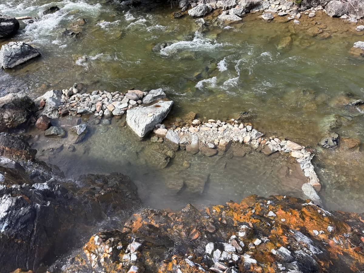 Natural rock lined hot spring pool along the river at lower loon creek hot spring idaho