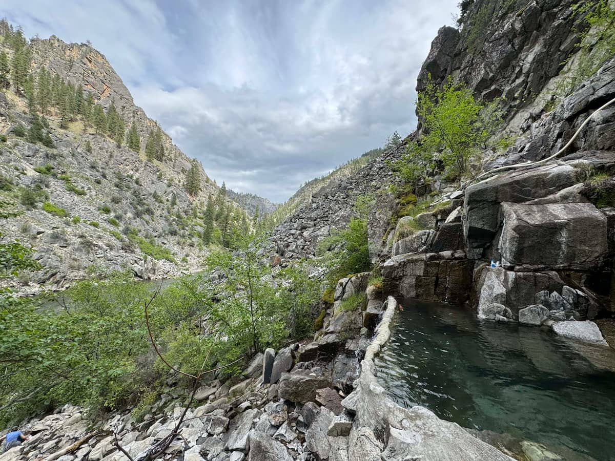 natural rock lined hot spring pool overlooking the salmon river at barth hot springs idaho