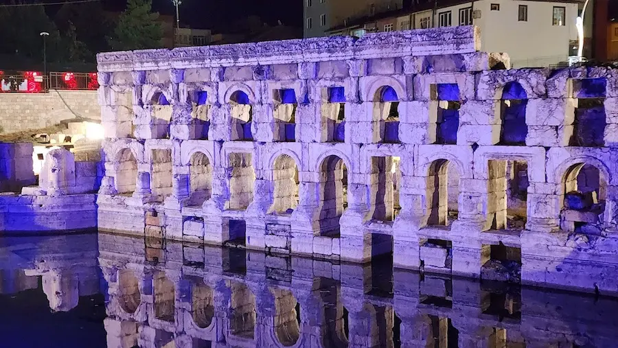 Historic roman thermal baths light up in the evening at sarikaya roman baths in turkey