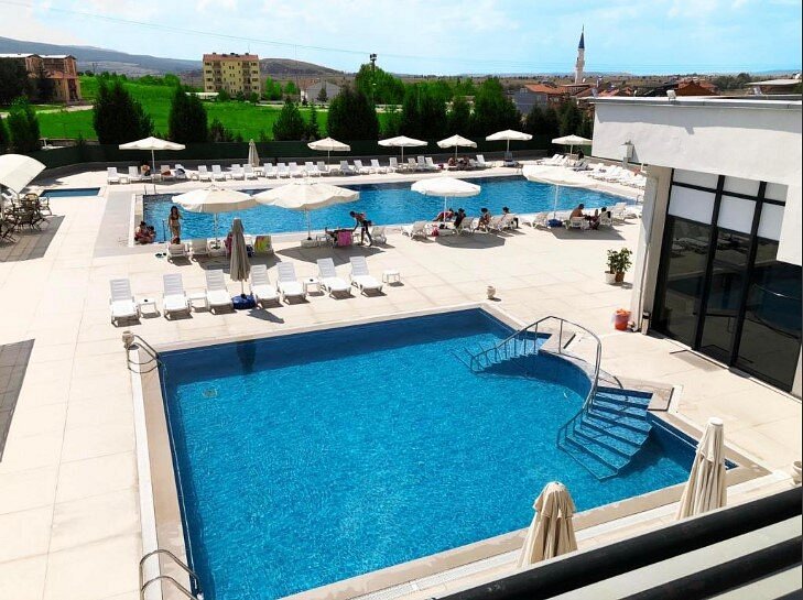 Outdoor hot spring pools in a resort setting at yoncali thermal springs in turkey