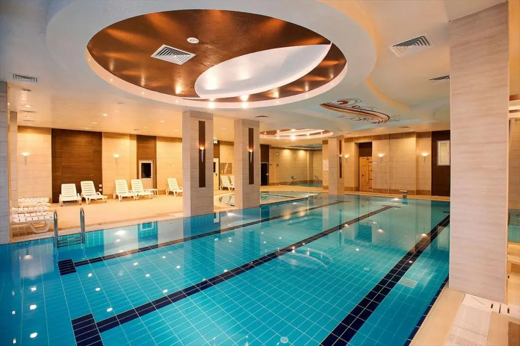 Indoor hot spring pool with swim lanes and loungers at haymana thermal springs in turkey