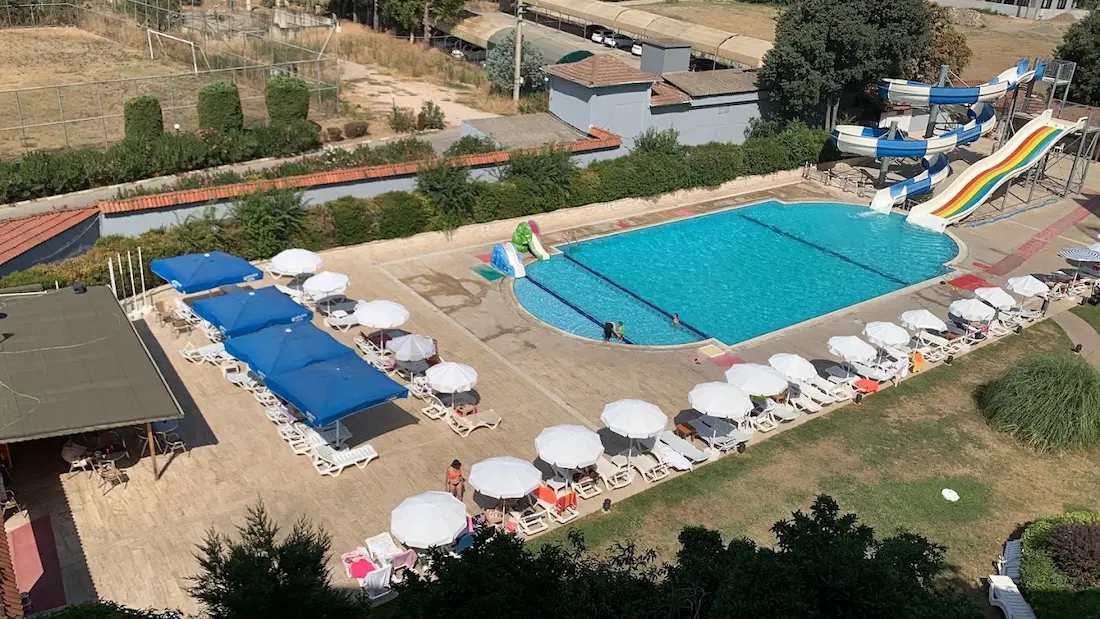 Outdoor hot spring pool area with sun loungers at gonen thermal spring in turkey
