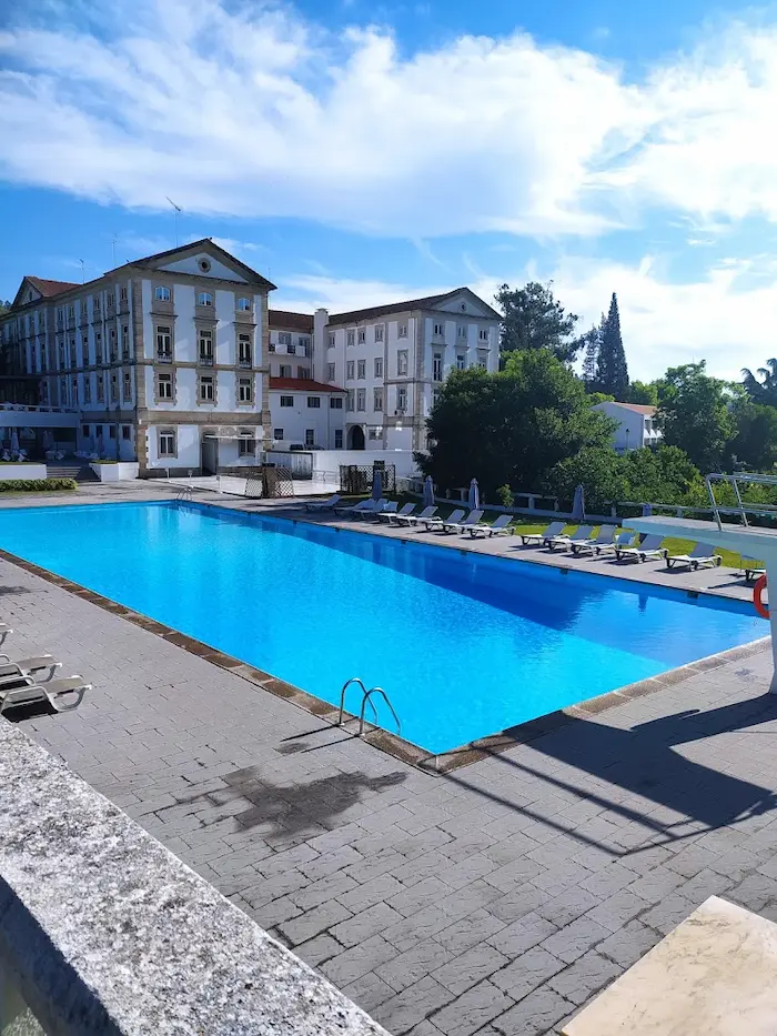 Outdoor hot spring pool in a grand resort setting at termas de felgueira in portugal