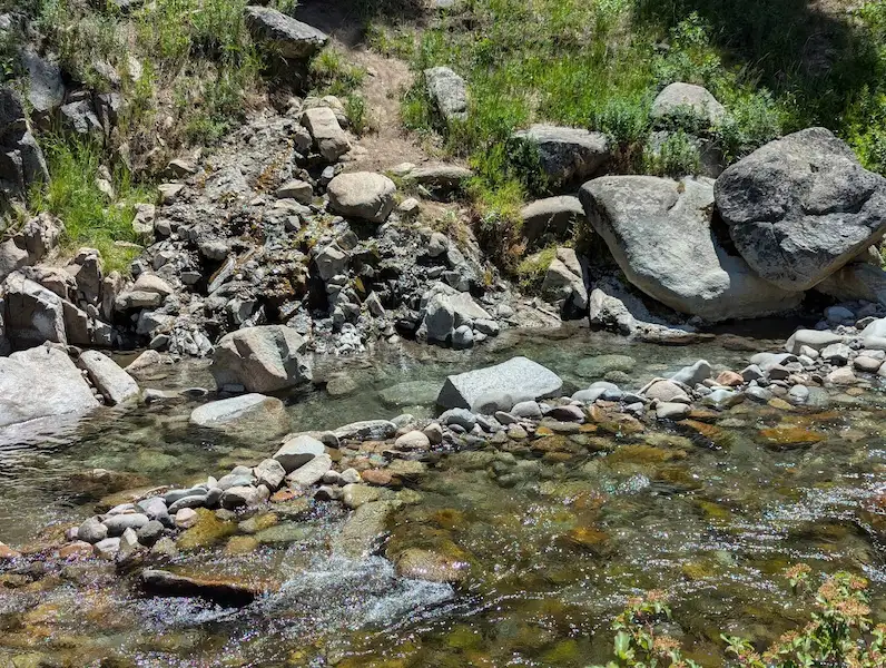 rock walled natural hot spring pools along warm springs creek at frenchmans bend hot springs in idaho