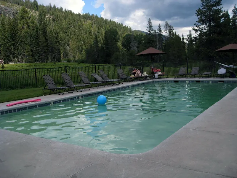 Outdoor developed hot spring pool with forested hills in the background at drakesbad guest ranch in california