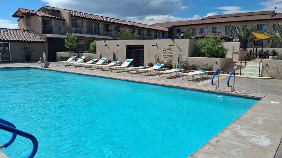 Outdoor hot spring pool surrounded by sunloungers in spa complex at relax hotel and spa in california