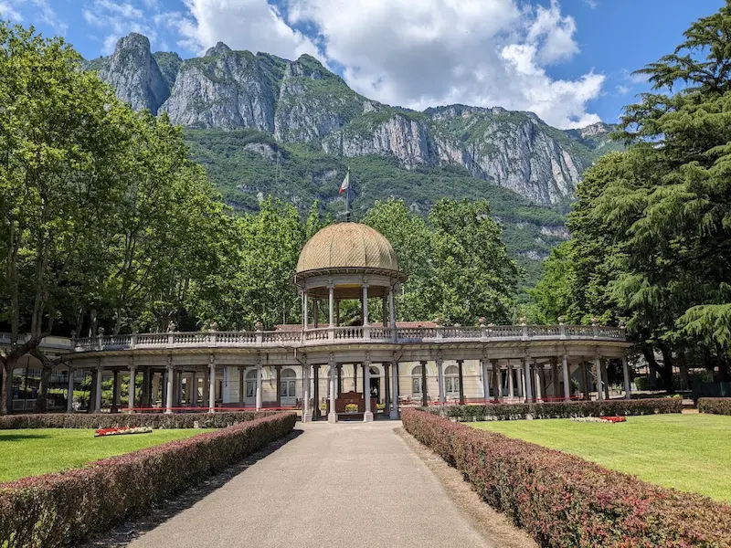 Historic thermal spa building with mountains in the background at terme di boario in italy
