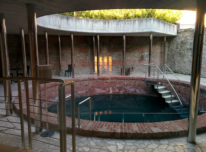 Historic brick lined hot spring pool in terme di acquired