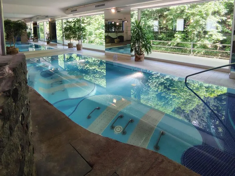 Indoor thermal pool with underwater massage seats at terme di rabbi in italy