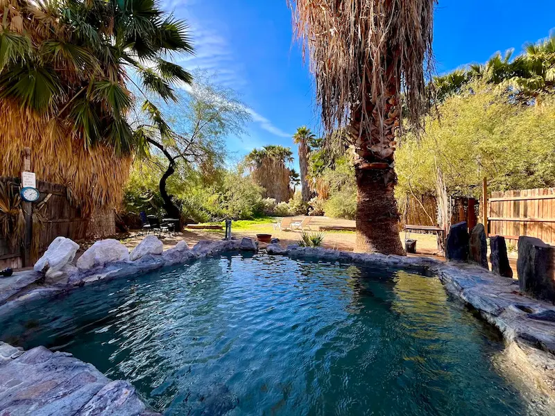 Outdoor developed hot spring pool in a desert resort surrounded by lush vegetation at el dorado hot springs in arizona