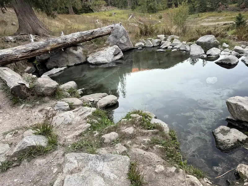 Outdoor rock lined natural hot spring pool at jerry johnson hot springs in idaho