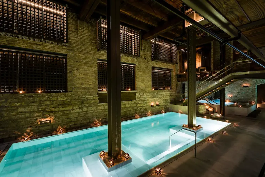 candlelit indoor thermal bath pools in a restored factory at aire ancient baths chicago