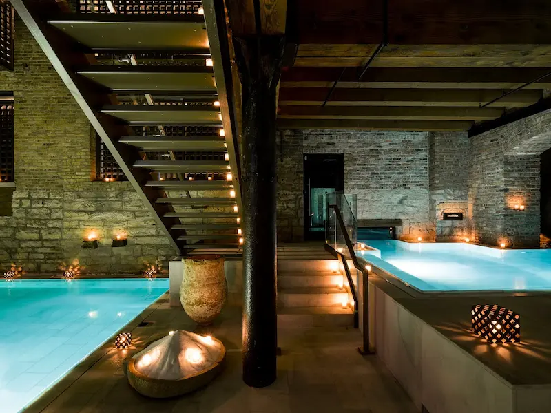 multiple candlelit indoor thermal pools at aire ancient baths chicago