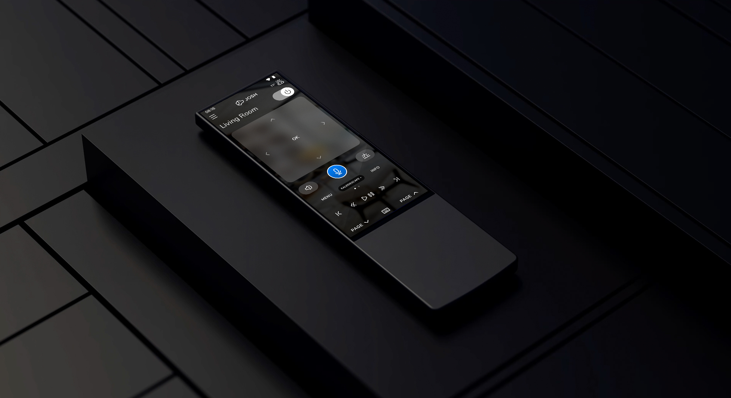 Josh remote resting on a dark tiled surface