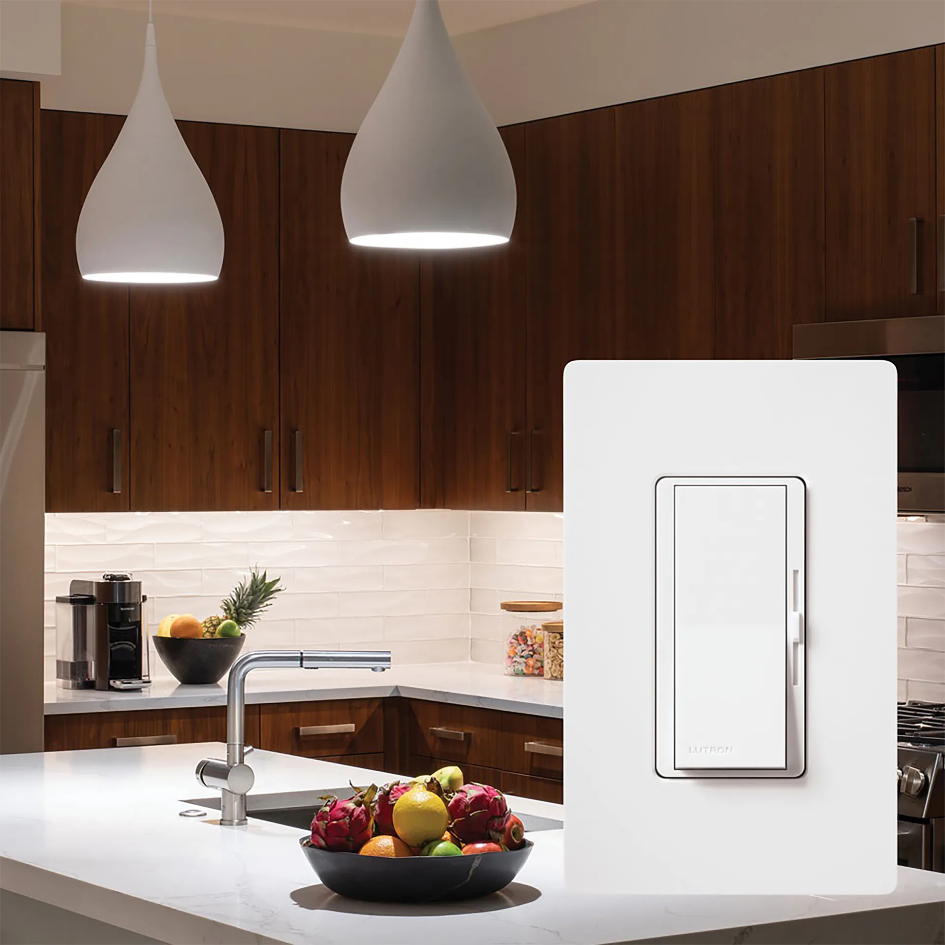 White Lutron Diva dimmer shown against a kitchen with lit pendant lights