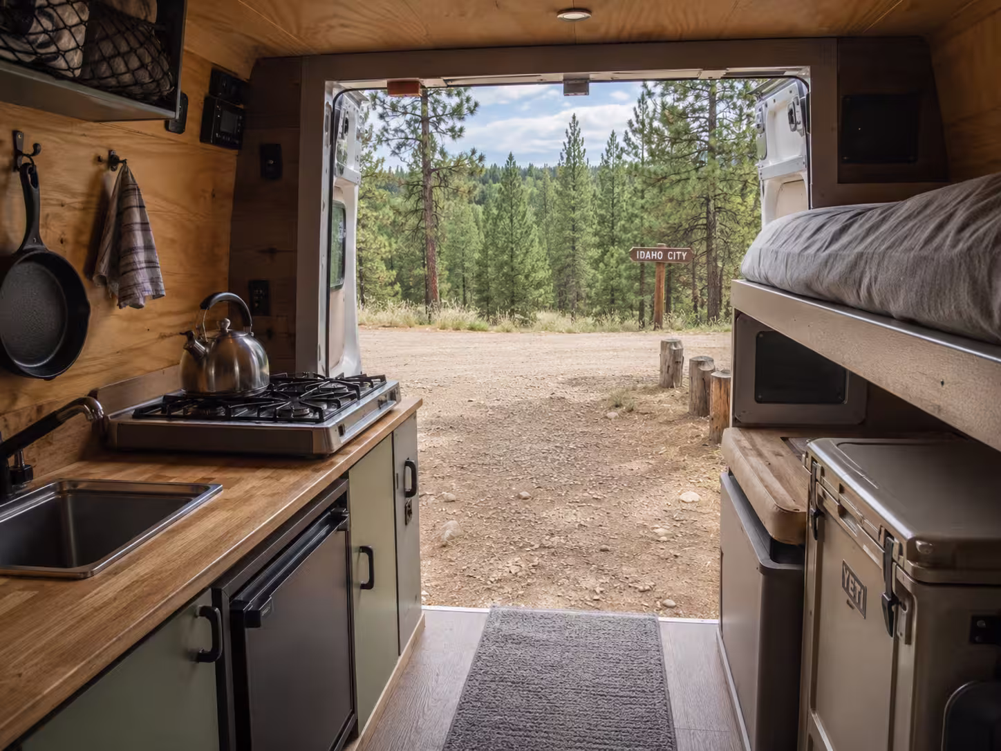 Camper van interior galley at an Idaho forest pullout