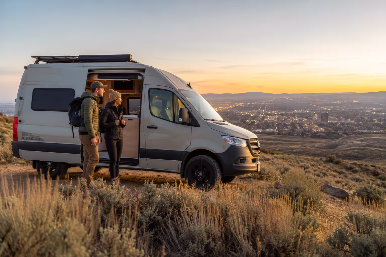 Camper van rental parked above the Boise foothills at sunset