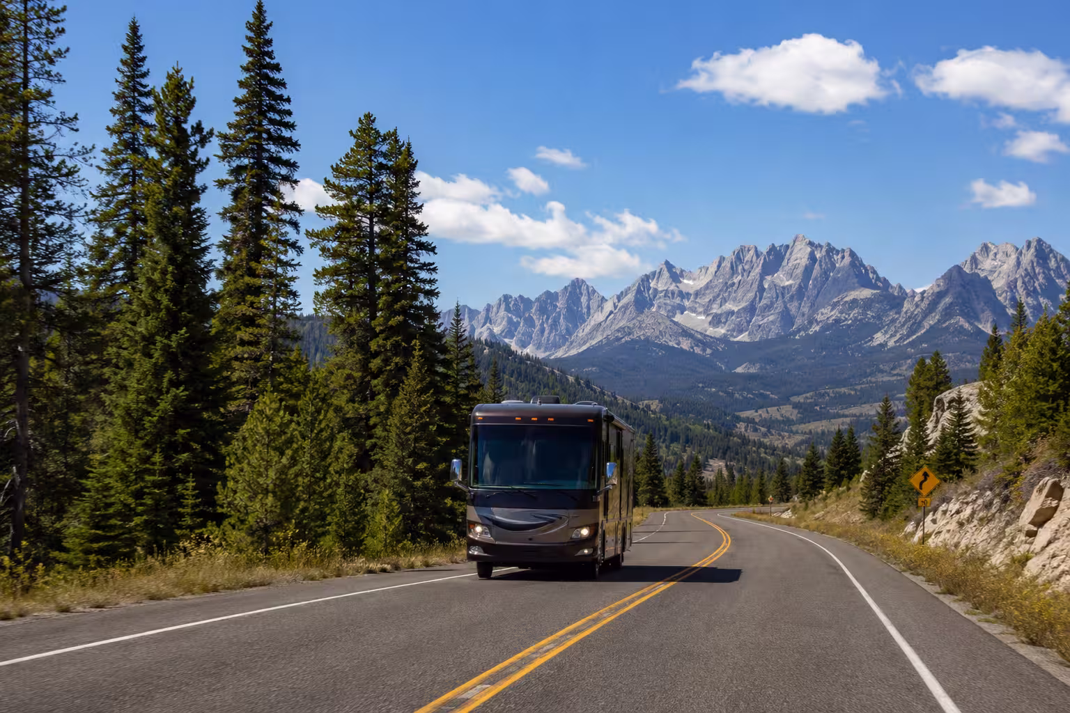 Class A motorhome driving toward the Sawtooth Mountains in Idaho