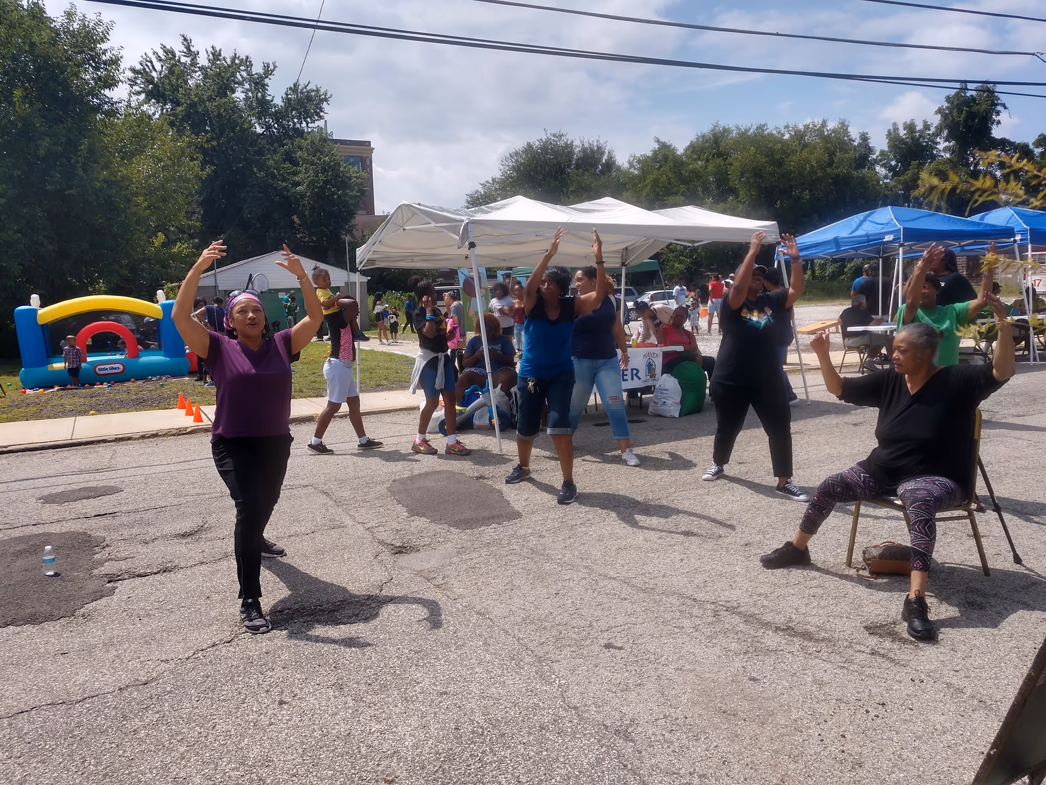 Myrna Patterson leads an accessible fitness routine outdoors at a wellness event.