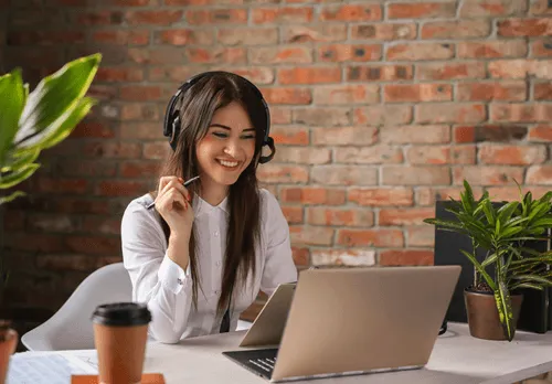 Woman with headphones on laptop