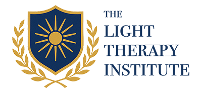 Light Therapy Institute logo featuring a blue shield with a gold sun and rays, flanked by gold laurel branches, with institute name in blue text.