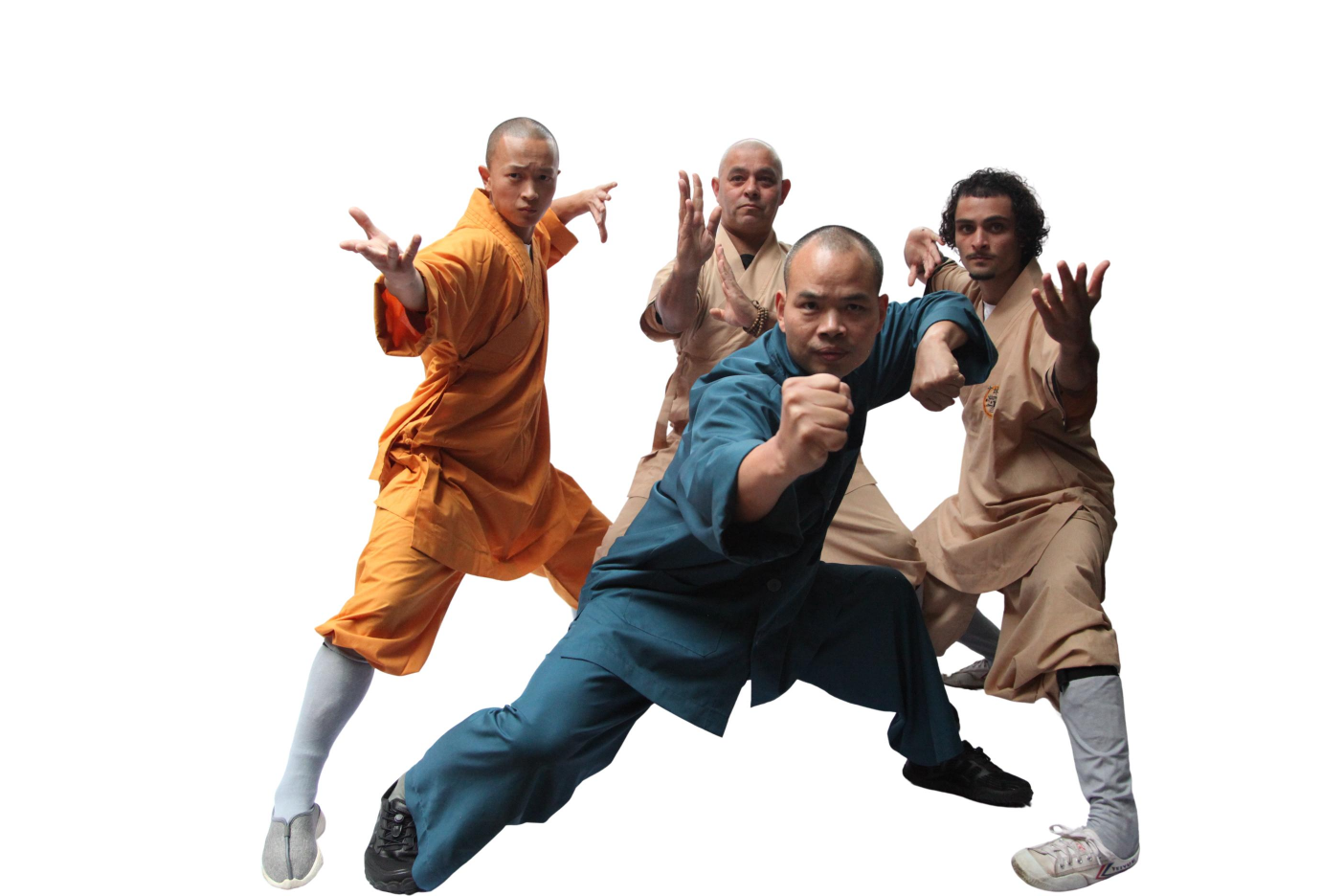 Four martial artists in traditional uniforms posing in dynamic kung fu stances.
