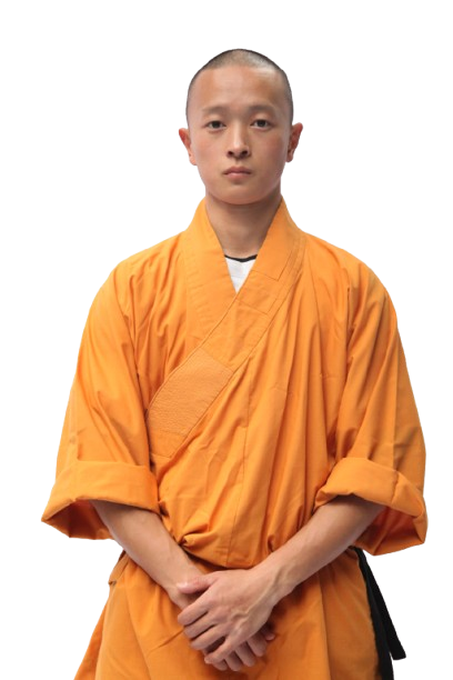 Young man wearing an orange traditional martial arts robe standing with hands clasped and looking forward.