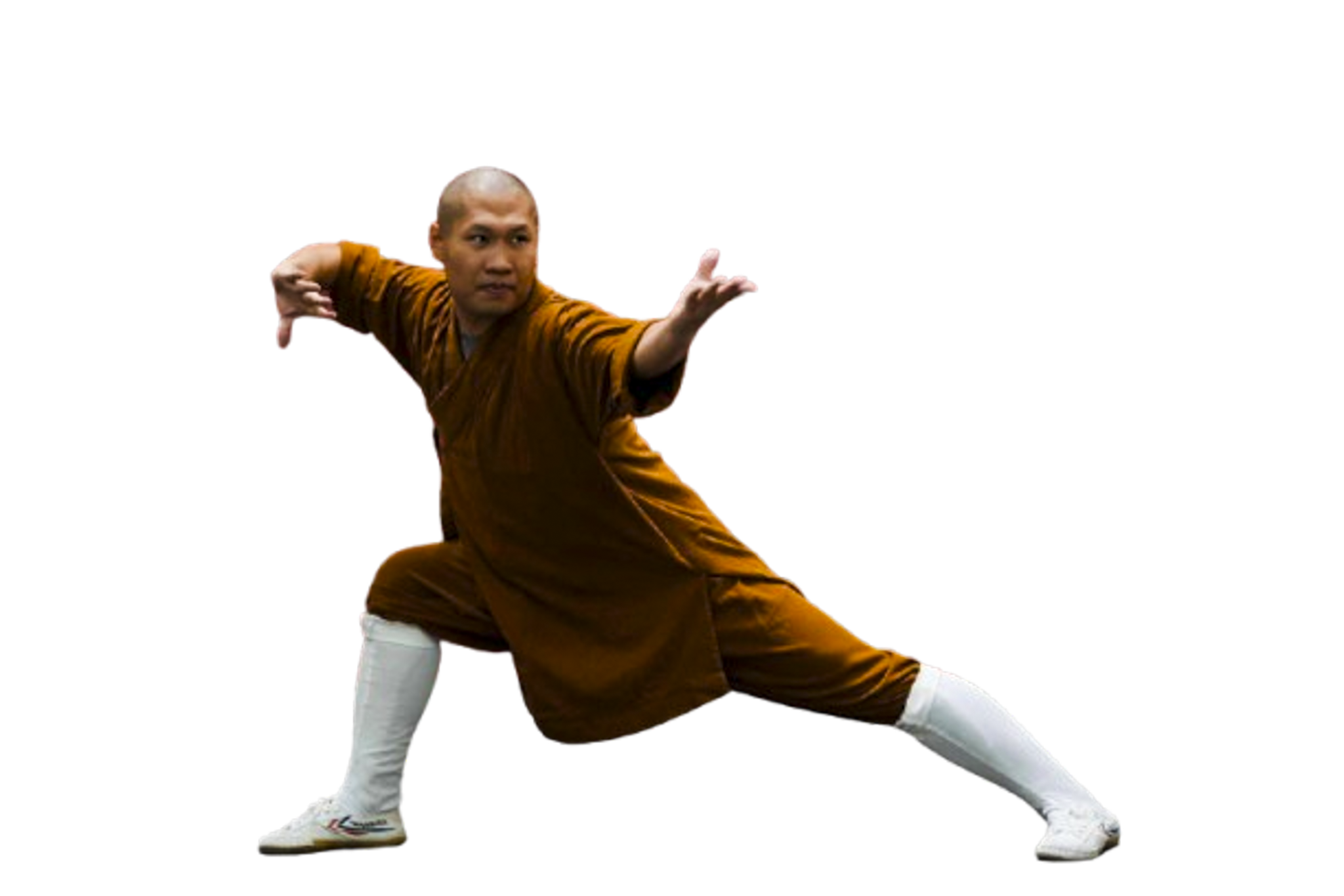 Person in an orange traditional martial arts outfit and white leg wraps performing a low lunge martial arts pose.