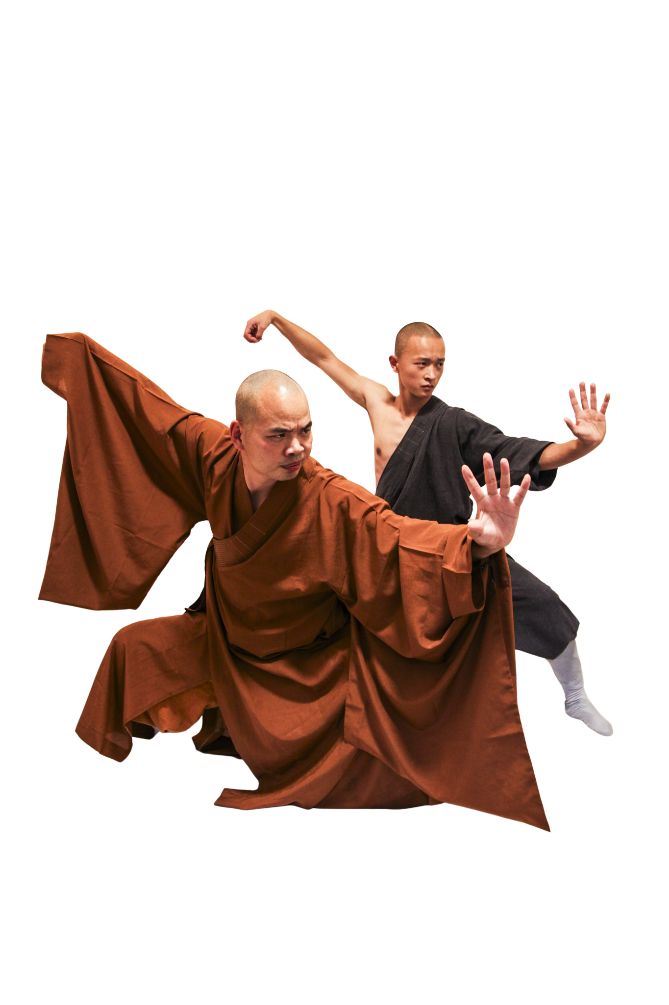 Two martial artists with shaved heads wearing traditional robes performing dynamic kung fu stances.