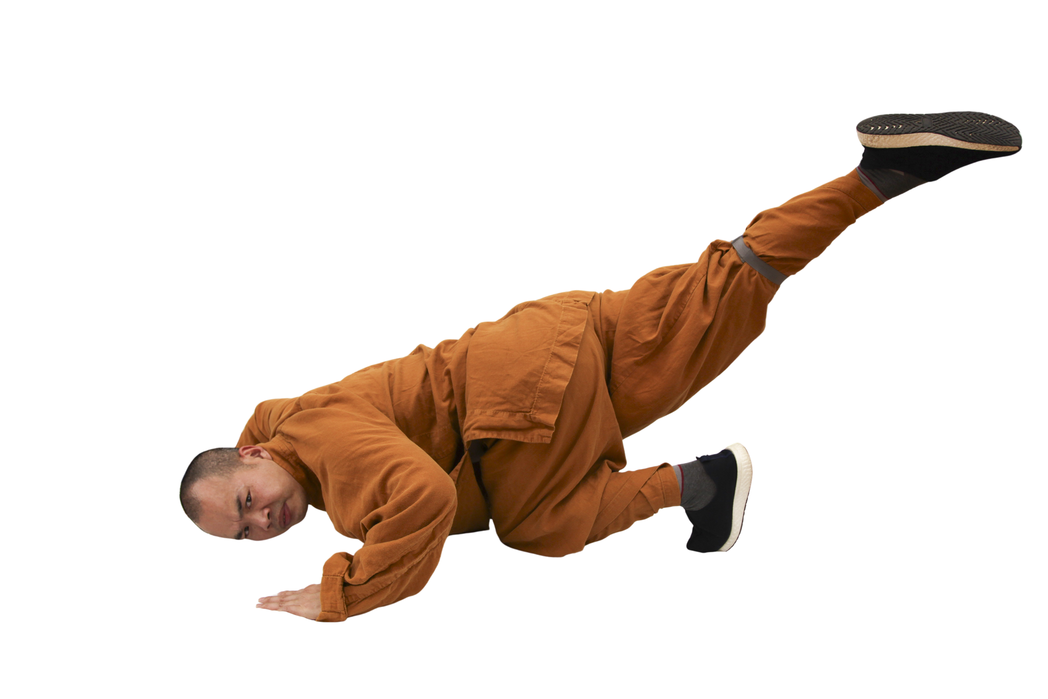 Man wearing orange outfit performing a one-handed breakdance freeze with one leg extended.martial art london Shaolin Xiu