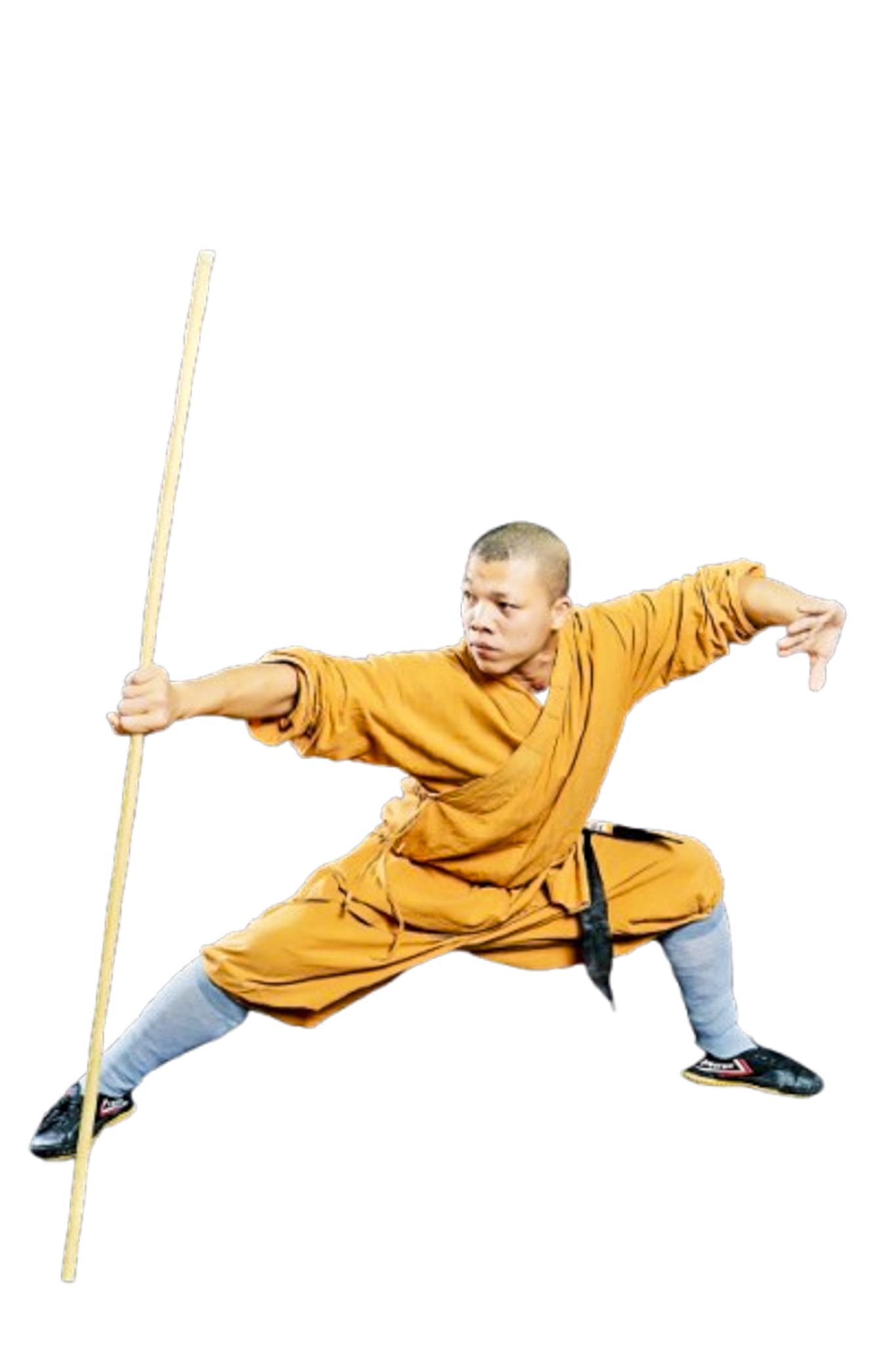 Martial artist in orange robe performing a low stance with a wooden staff.