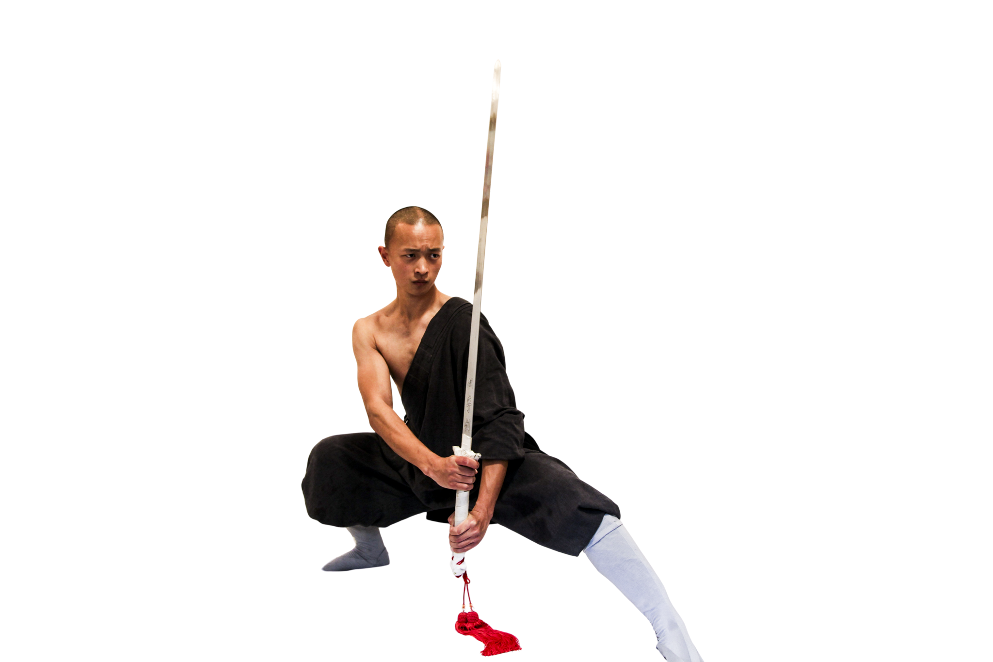 Man in black martial arts attire and white leg covers in a low wide stance holding a vertical sword with a red tassel.martial art london Shaolin Xiu