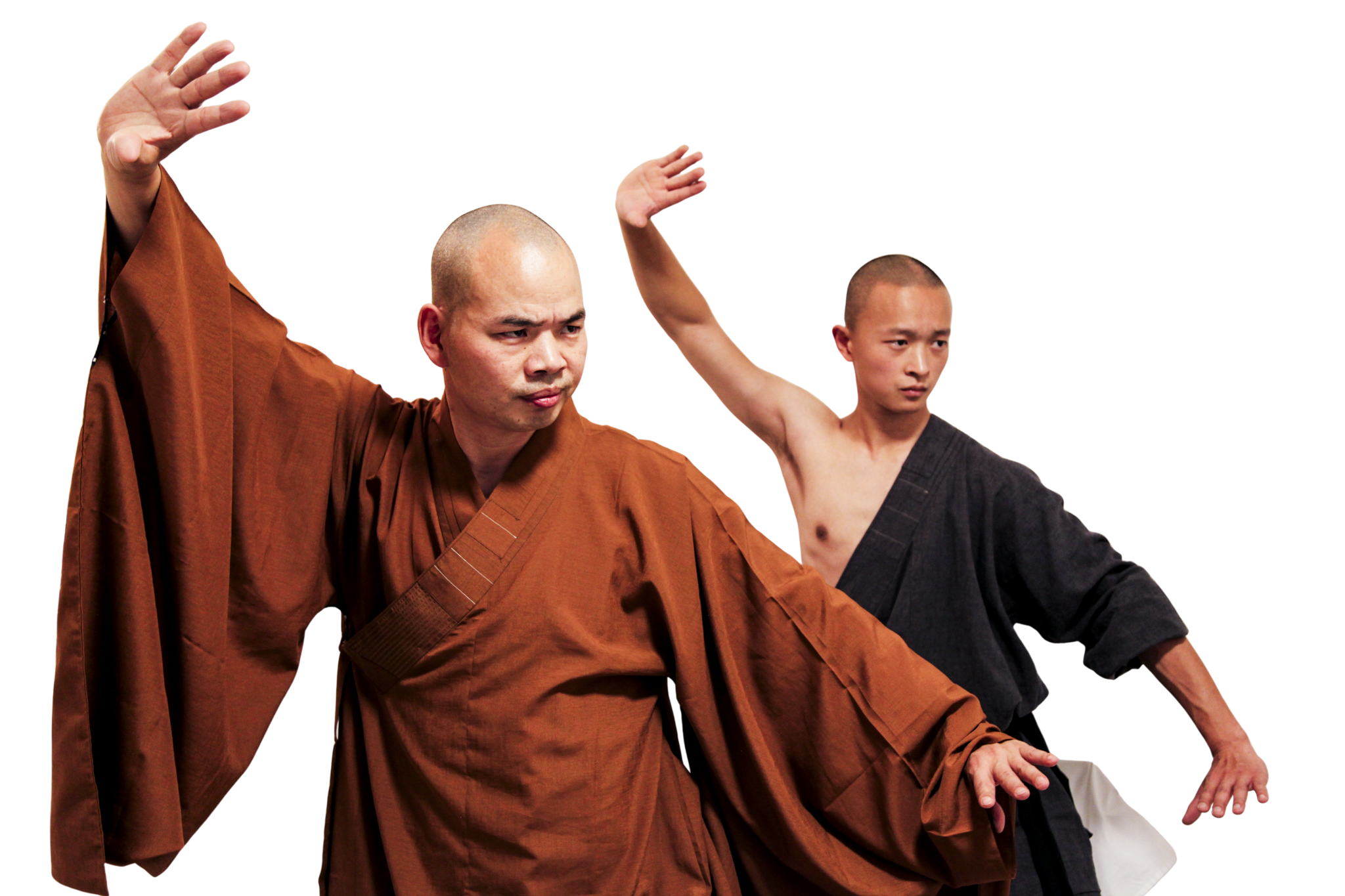 Two martial artists in traditional robes performing synchronized kung fu stances.martial art london Shaolin Xiu