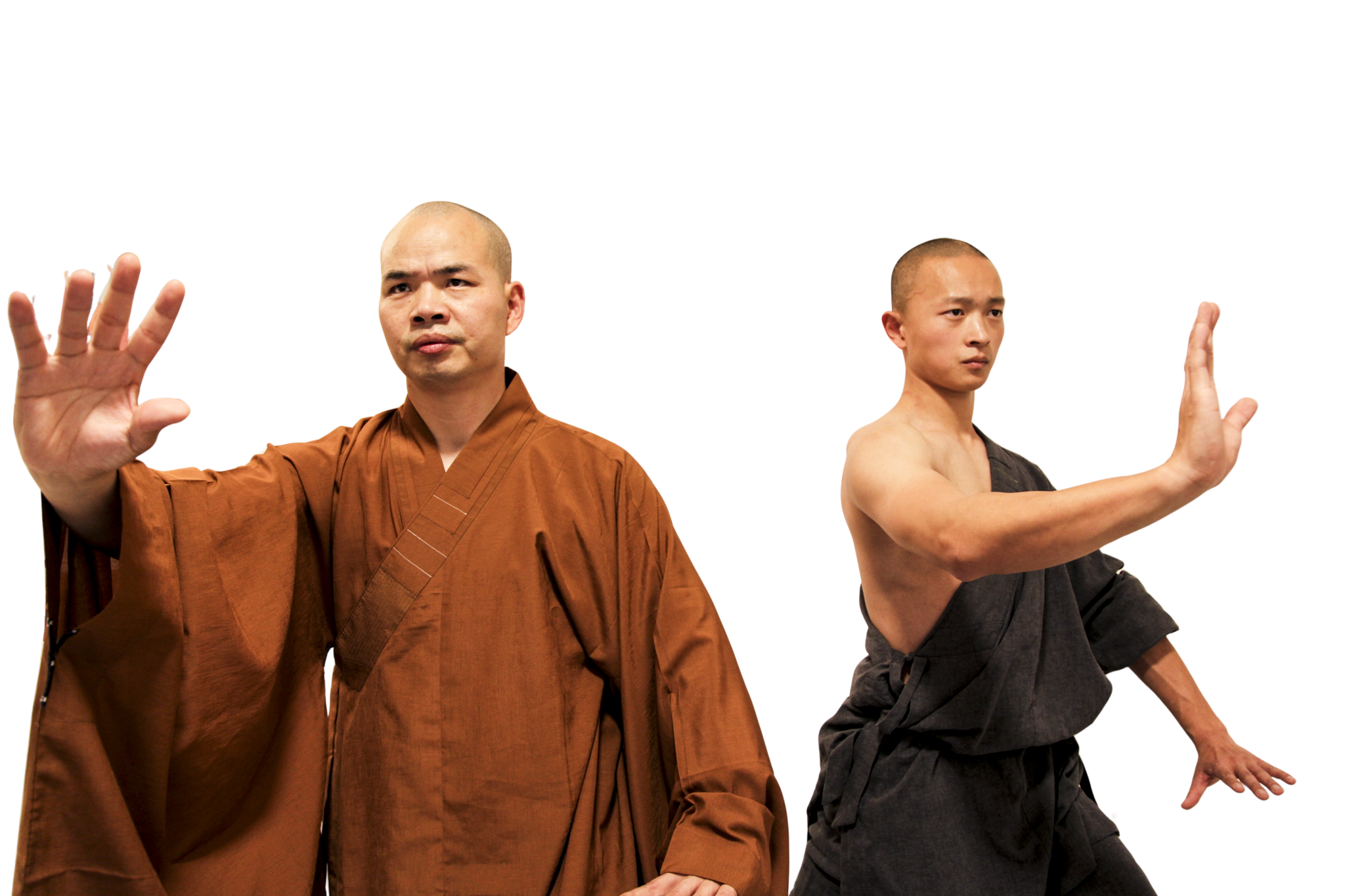Two martial artists in traditional robes striking defensive poses with extended hands.martial art london Shaolin Xiu