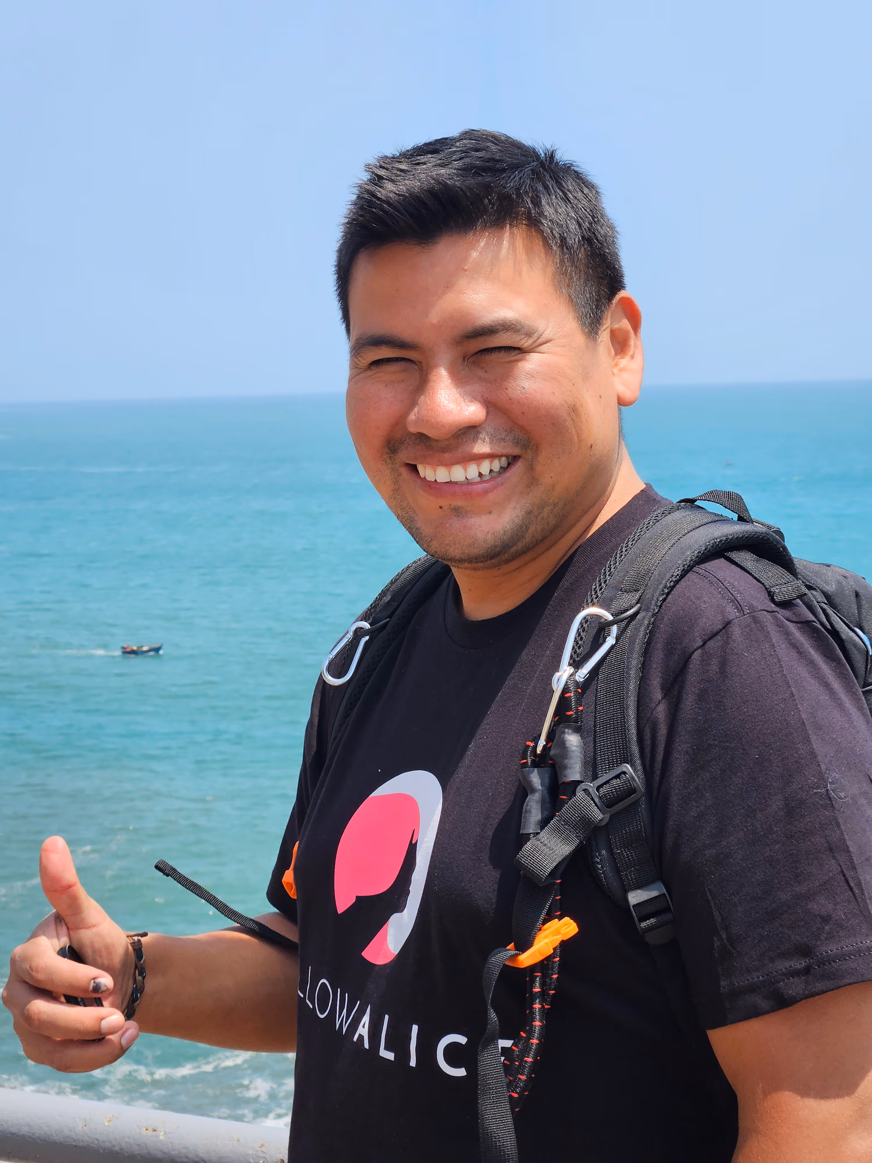 Peruvian man smiling with ocean behind him