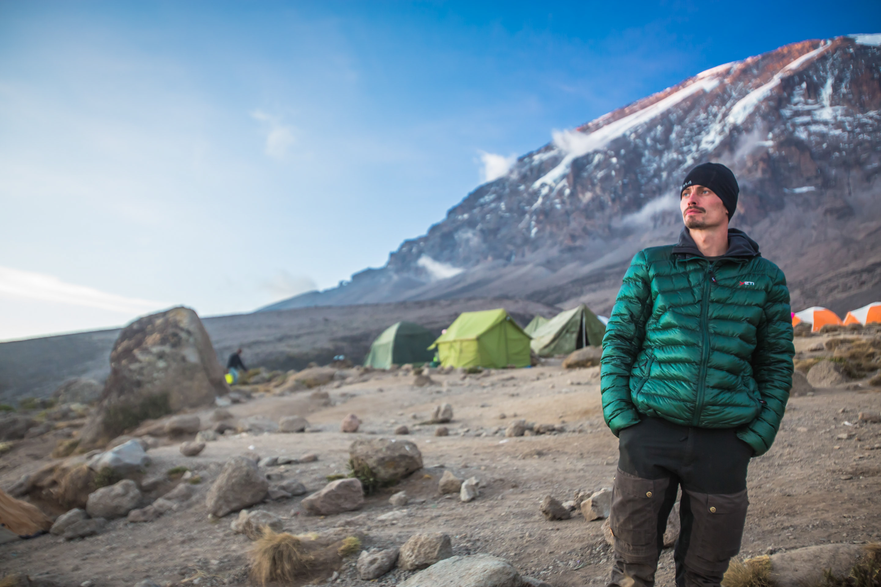 Shira Plateau. Man with Mount Kilimanjaro in the background. 