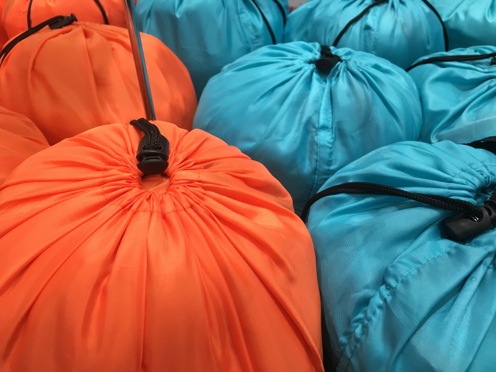 Ours. Sleeping bags in drawstring compression sacks