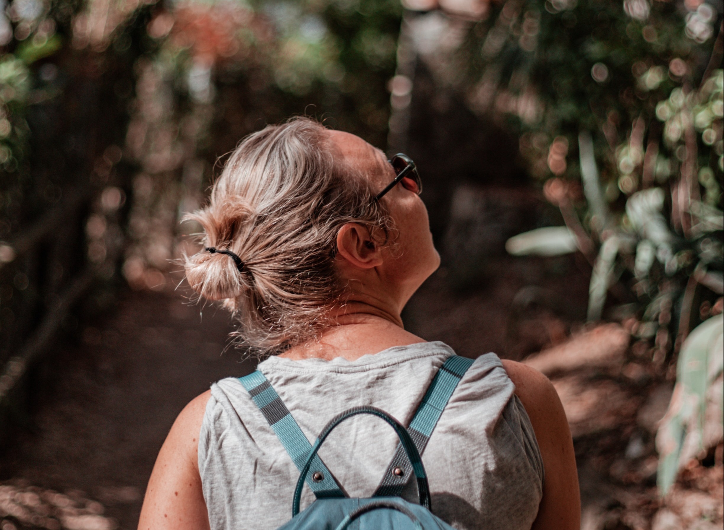 Woman wearing a backpack walking uphill 