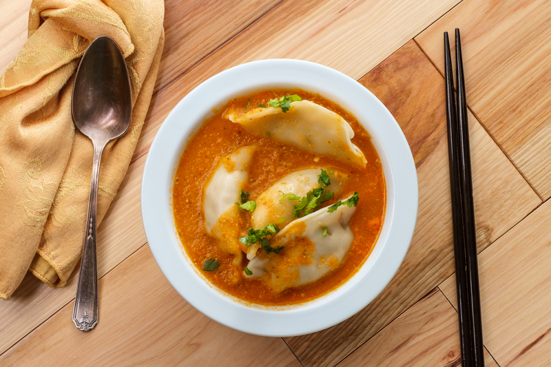 Momos in chilli achar, view from top, spoon and choptsticks, Nepali food cuisine