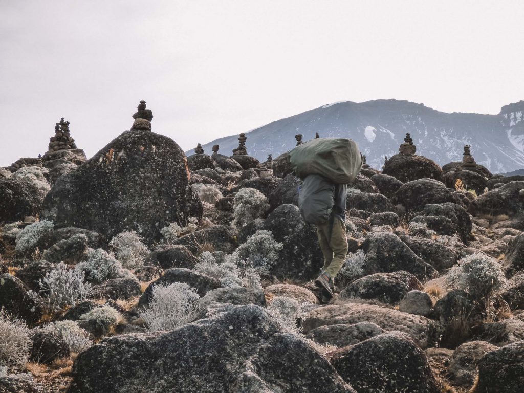 porter-passing-a-rock-formation-on-Kilimanjaro-1024x768.jpg
