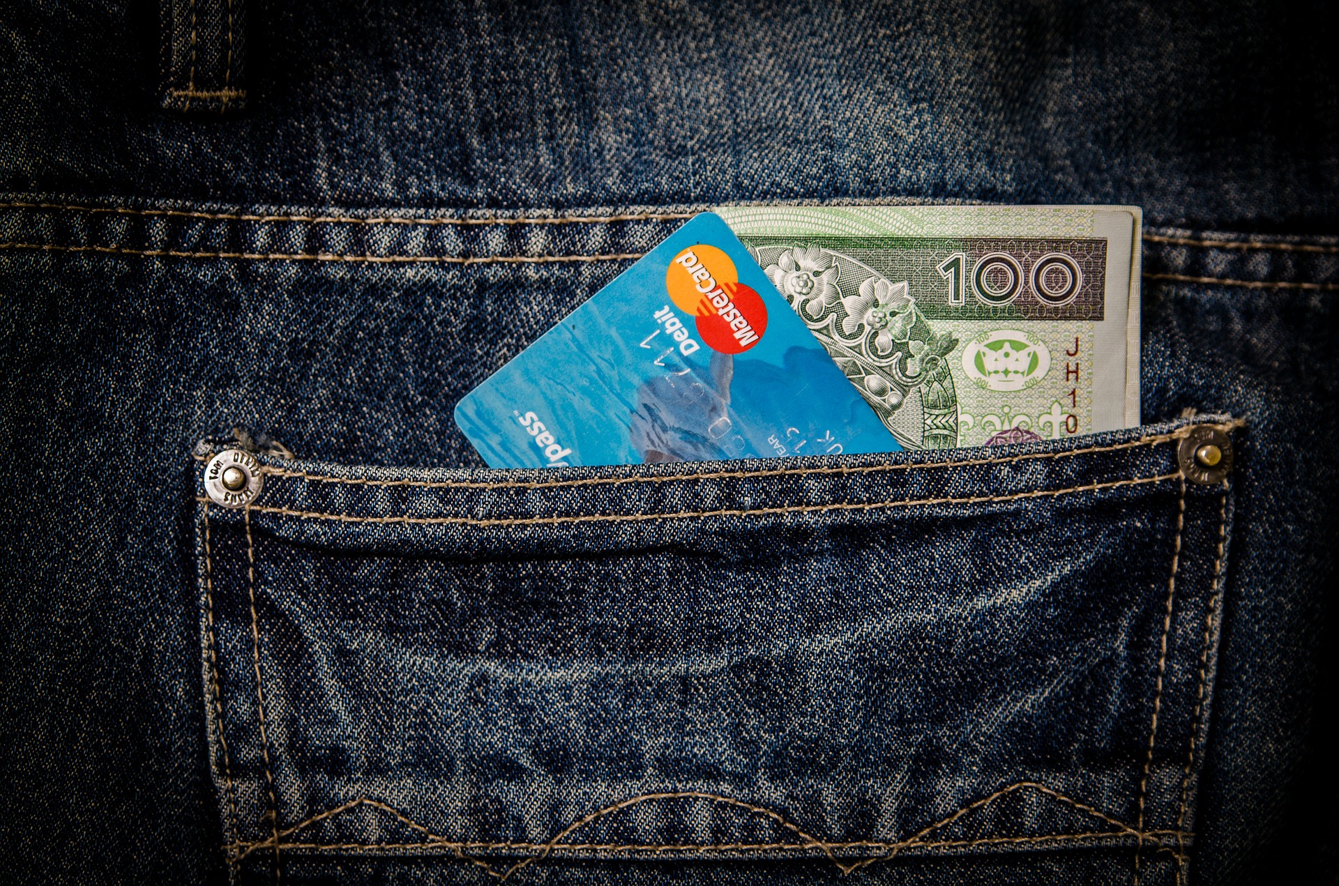 Money and bank card in back jean pocket