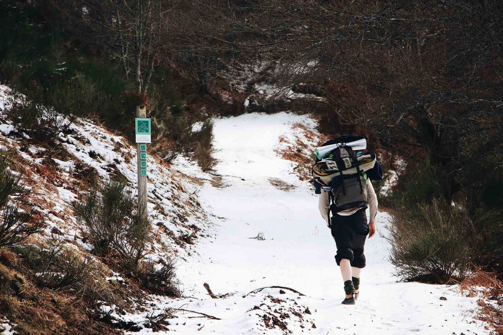 Man-walking-along-marked-path-in-snow-1024x683.jpg