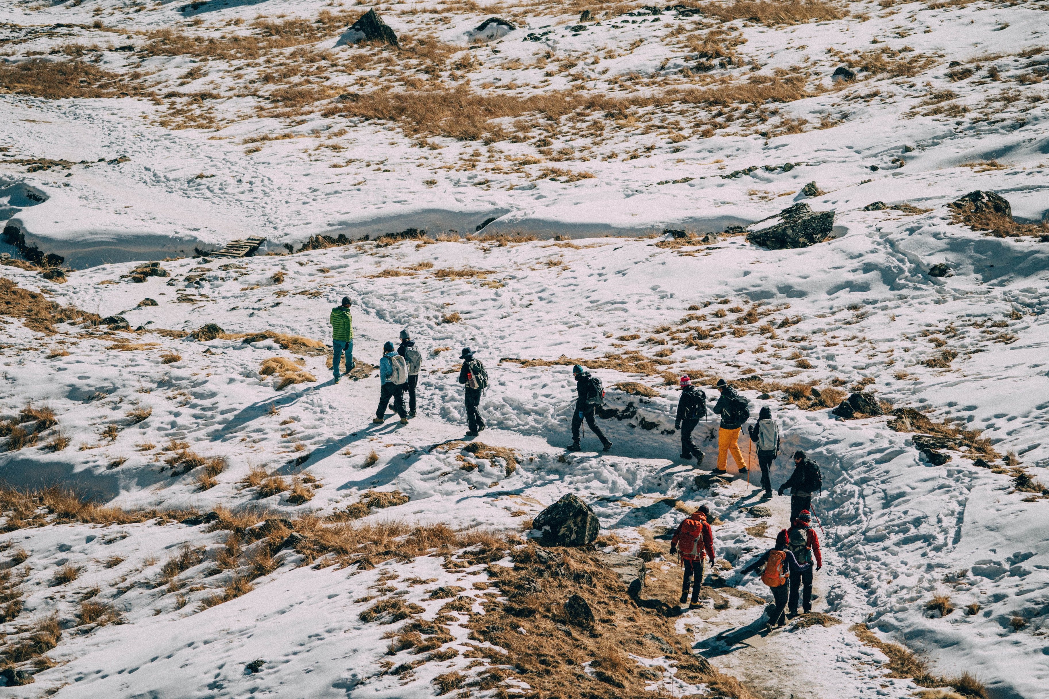Everest Base Camp trekkers walking along snowy trail