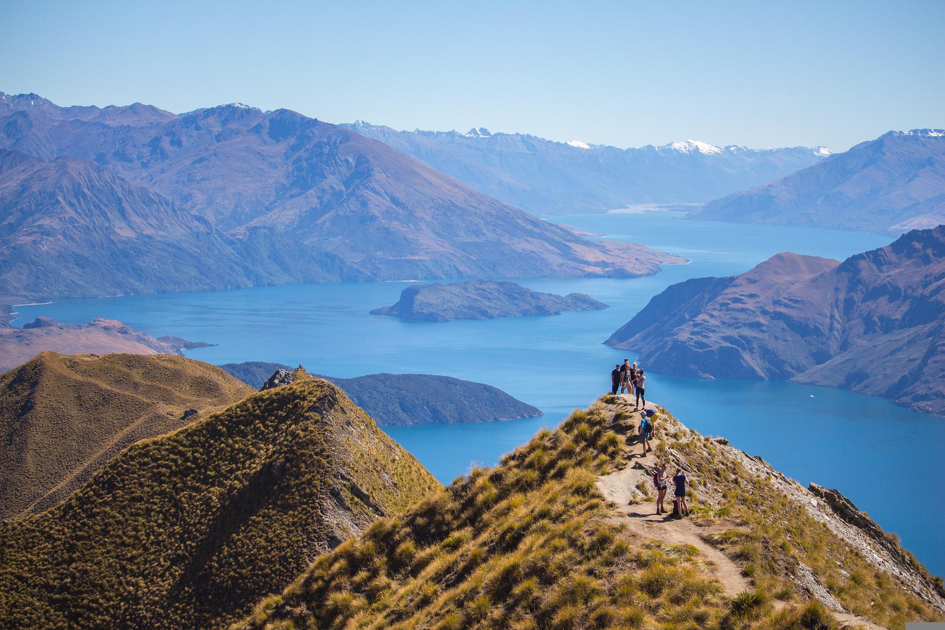 Group of hikers in mountains and by lake
