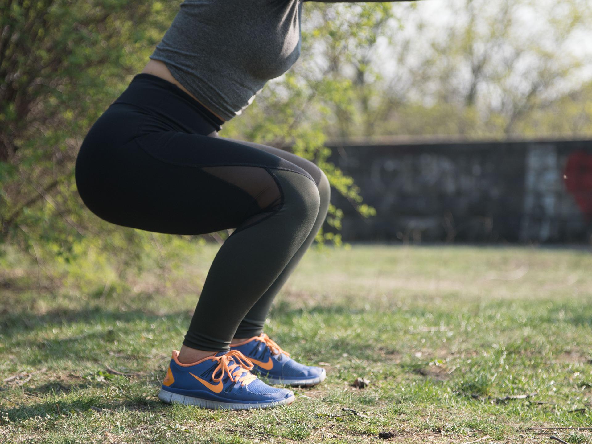 Women doing outdoor squats exercise